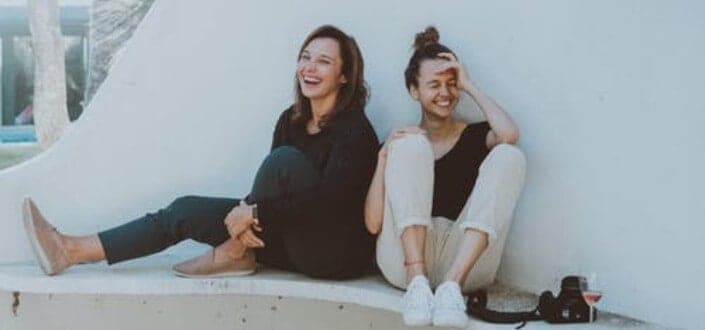 Two girls sitting at a bench