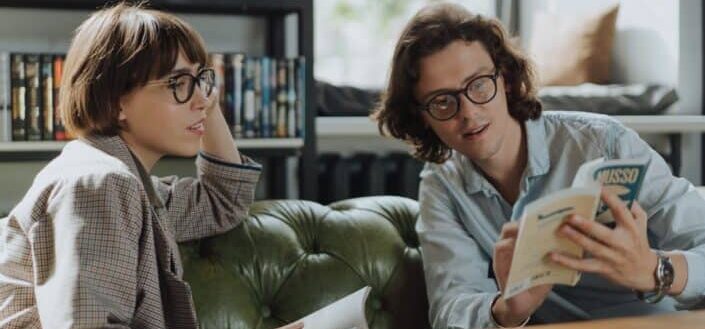 woman-in-gray-sweater-sitting-on-green-couch-pexels