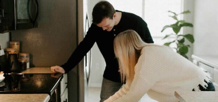 woman putting food on a baking oven