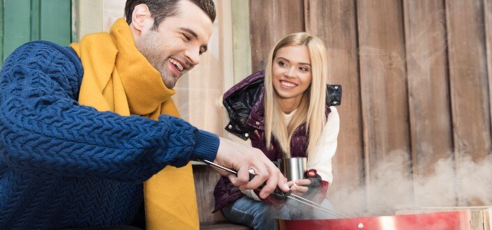 man happily cooking to his girl