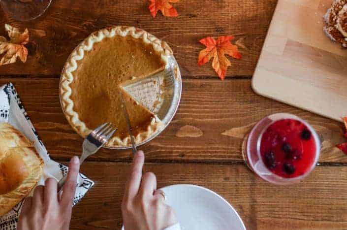 Delicious-looking pie being sliced.