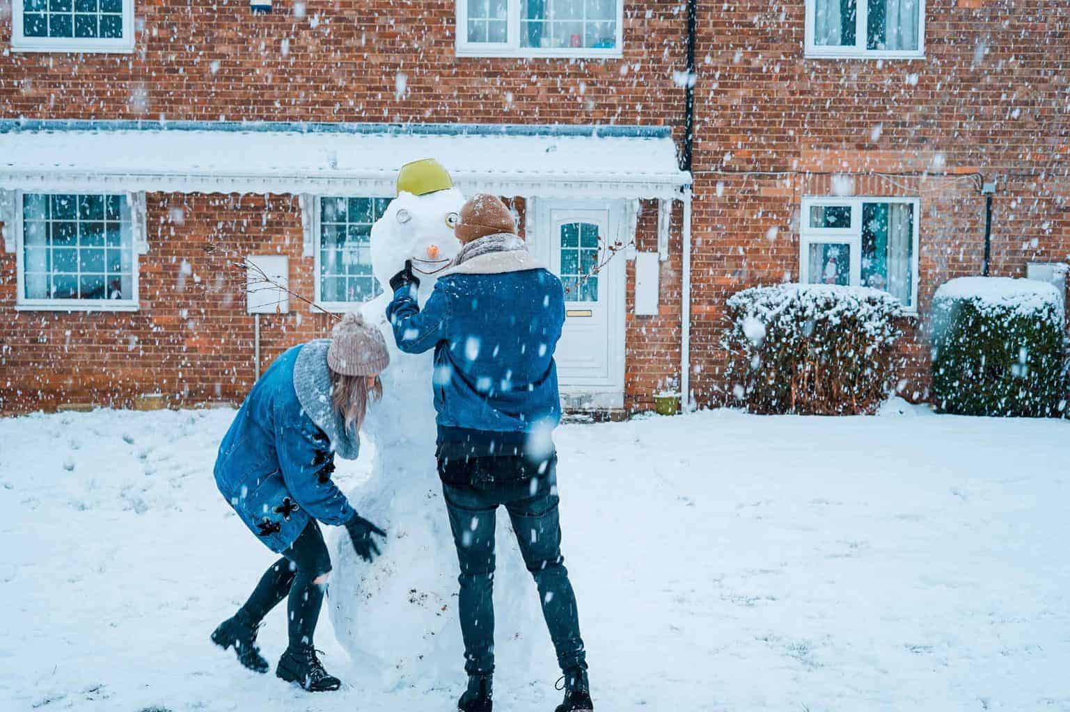 Couple building a snowman