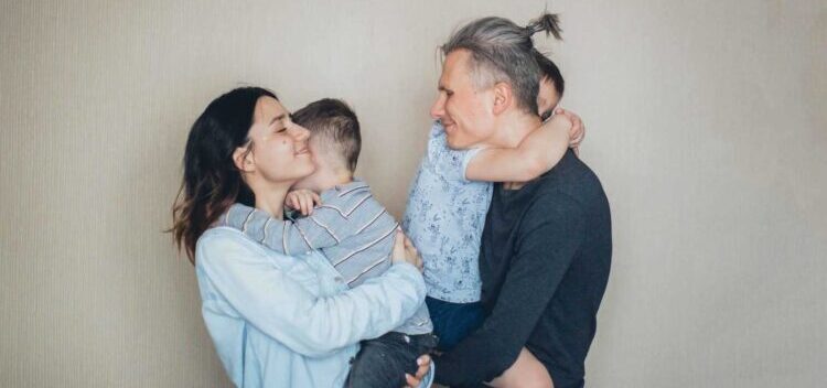 mom and dad hugging their kids