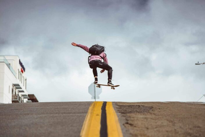 man skateboarding on the road