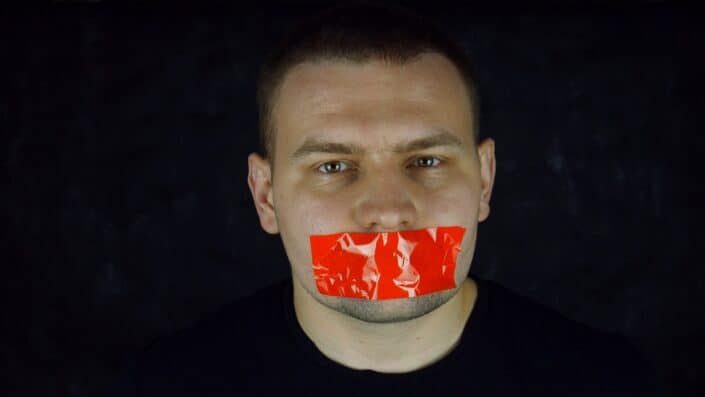 Man with scotch-tape on his mouth