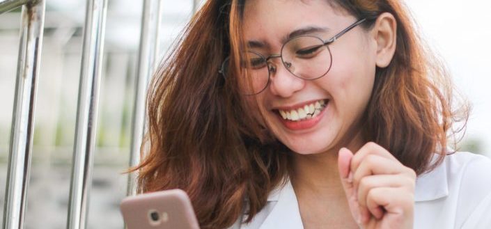 happy young woman wearing a white top