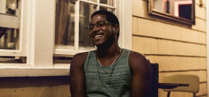 Man laughing at a balcony of their house