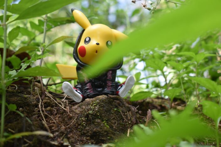 pikachu plush toy on brown tree trunk