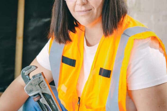Woman holding a plumbing tool