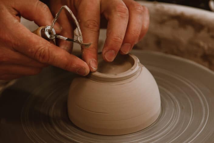 A potter making a pot out of clay