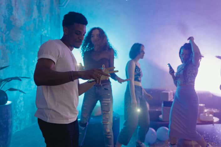 A man holding his mobile phone while dancing