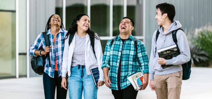 Group of students walking and laughing together