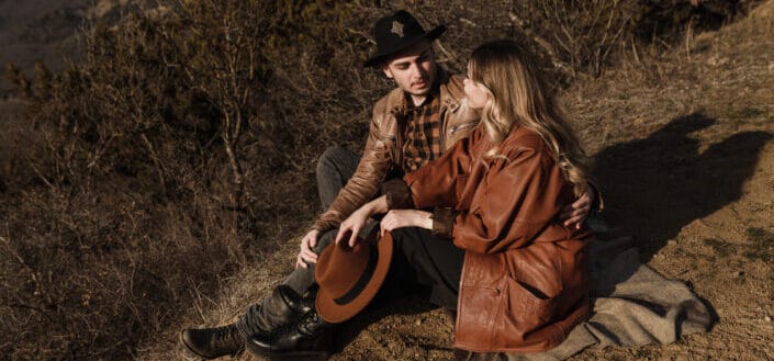 A couple sitting in field