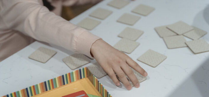 A person s hand touching a card