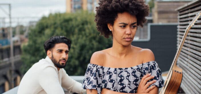Annoyed lady turning back on a guy