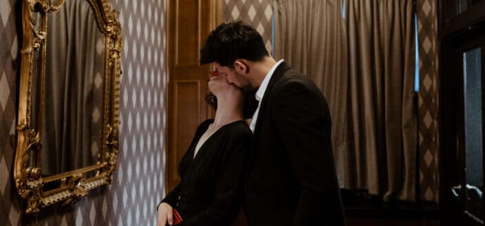 Stylish Man Kissing a Woman in the Neck