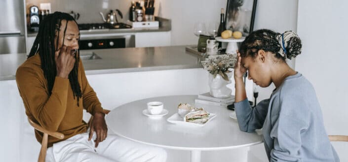 Couple arguing at kitchen table