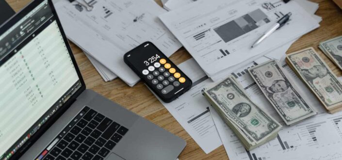Banknotes and Calculator on Table