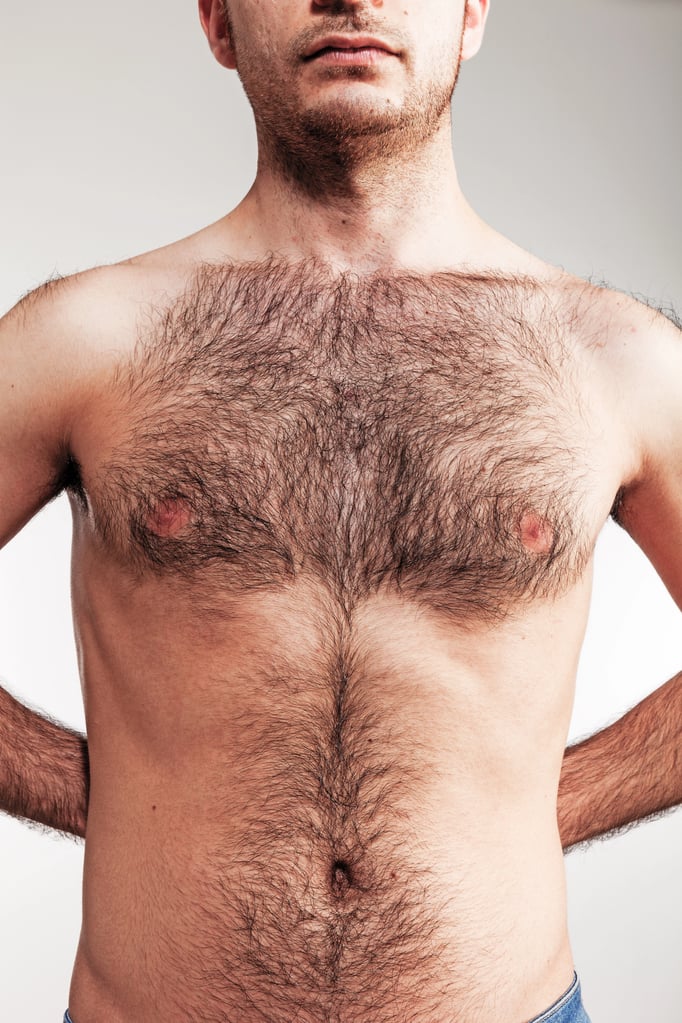 Man with shaped hairline (Defined Border) hairy chest on white background.