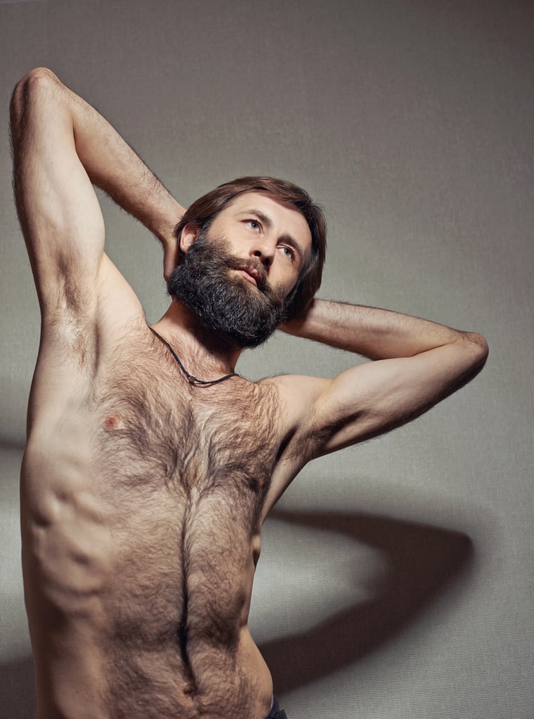 Hairy man with full and natural chest hair.