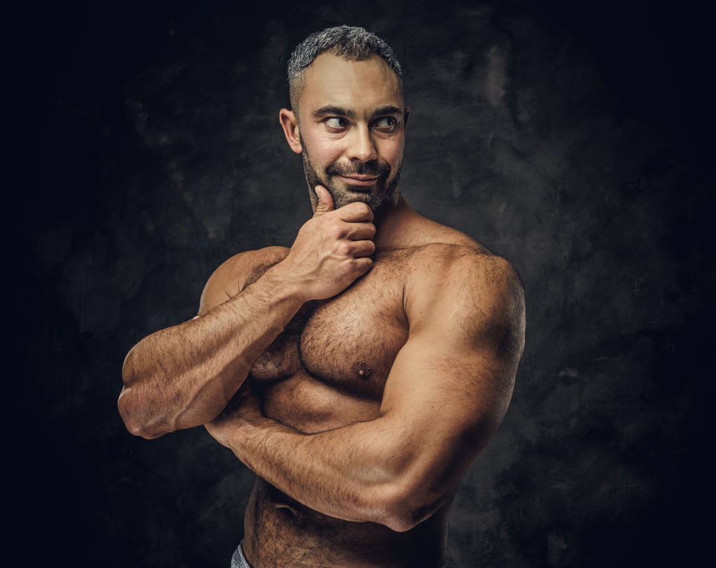 Middle aged man body builder with Bearded man with Natural But Groomed chest hair.
