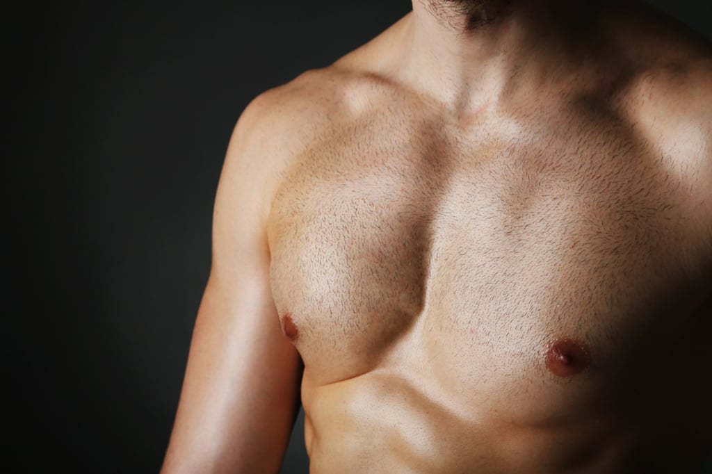 Muscle young man with trimmed short stubble look chest hair.