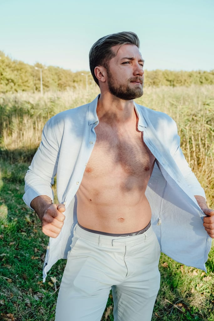 Bearded man with white shirt and Man with muscles with Natural But Groomed chest hair.