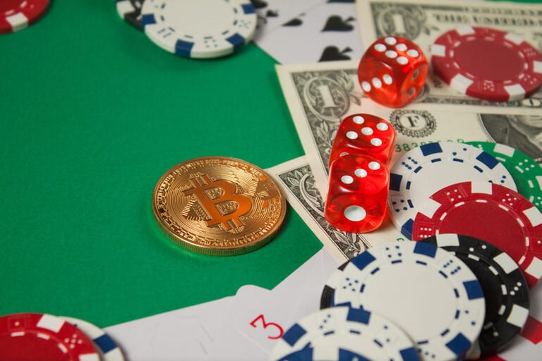 Bitcoin token, dice, and casino chips symbolizing fast, always-on BTC dice gaming and the need to stay in control.