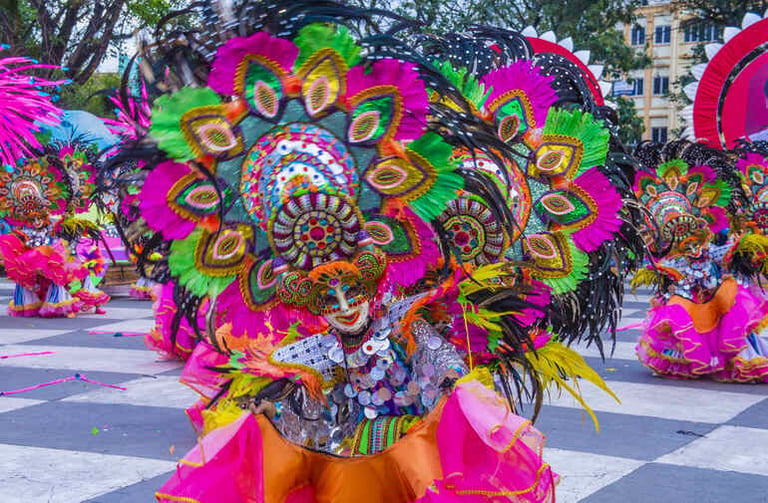 Digital Filipino carnival dancers in colorful costumes at a lively Peryagame event.