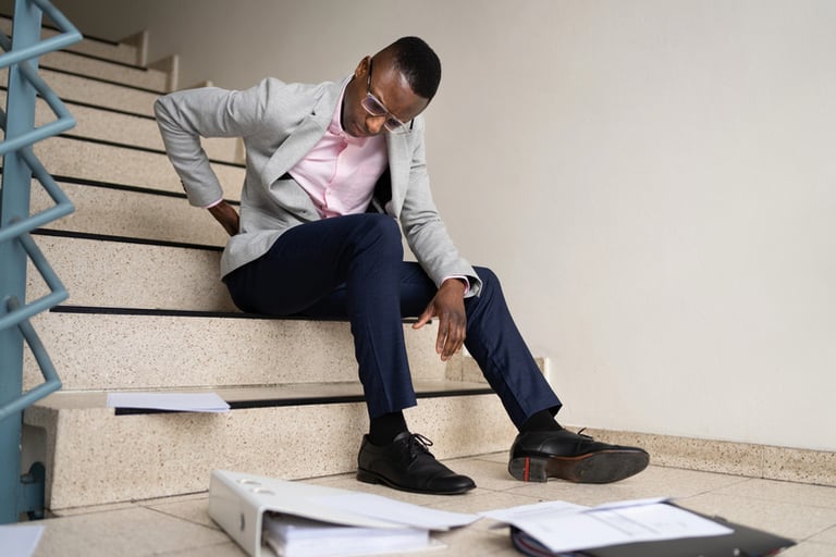 A man slipping on a stair, illustrating slip and fall safety awareness.
