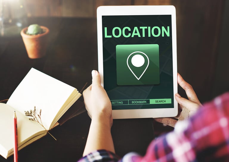 Person holding tablet changing Netflix location settings to unlock more shows worldwide