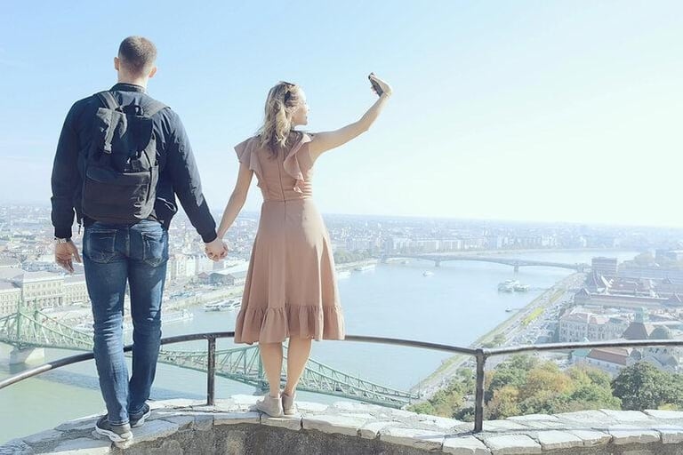 A couple meeting outdoors in an urban environment after a while.