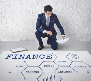 Businessman reviewing financial data beside a finance chart, representing financial readiness and planning for modern men.