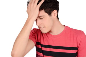 Man looking stressed while struggling to remember words mid-sentence, appearing frustrated during conversation.