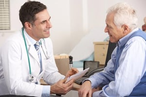 Male doctor discussing preventive health screening results with an older patient during a comprehensive men's health checkup consultation in a medical clinic in Bangkok.