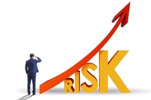 Business professional viewing rising risk graph, symbolizing calculated risk and strategic thinking.