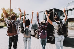 Group of travelers boarding a coach for group travel in Birmingham, UK.