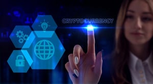 A trader interacting with a glowing digital interface displaying the word Cryptocurrency alongside tech icons.