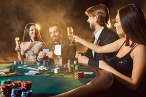 Elegant casino night with friends playing cards at a casino table in formal attire.