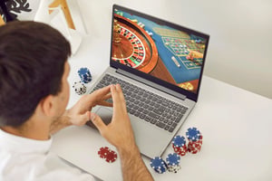 Young man playing poker on an online casino club website.