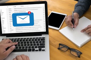 Man using a laptop to organize and sort his email account, clearing digital clutter and managing messages.