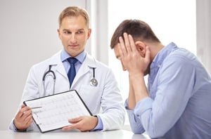 Male patient discussing his health with a doctor during a medically supervised detox consultation.