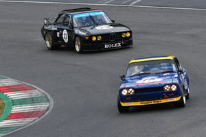 Two race cars competing on a professional motorsport track during a high-speed racing event, highlighting the season’s top motorsport action.