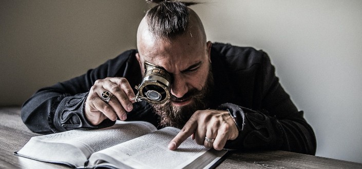 Man reading with magnifying glass