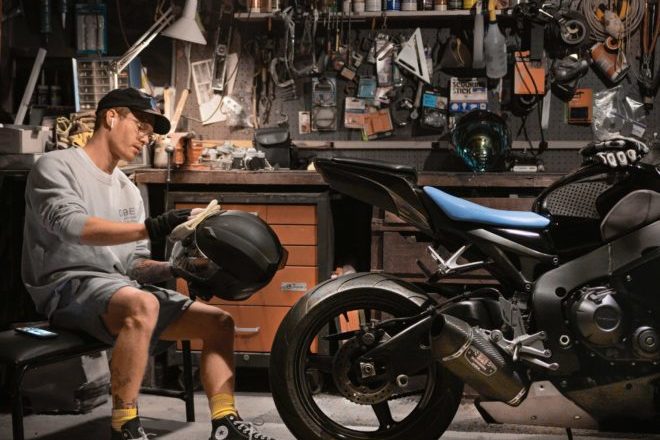 Garin Chadwick cleaning helmet and CBR 1000rr street bike in LA garage