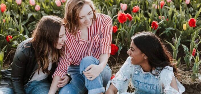 friends bonding together in a flower garden