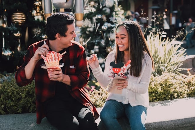 a couple laughing while eating their snacks - date questions