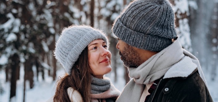 woman looking at a man while outside in the snow