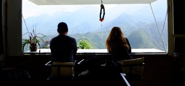 silhouette of couple looking outside