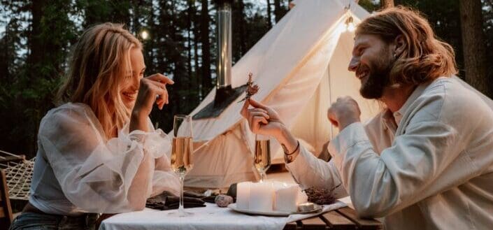 a couple having a date by a tent